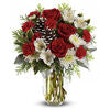 Bouquet of red roses and white flowers in a clear vase on a white background