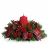 Decorative Christmas arrangement with red candle and greenery on a white background