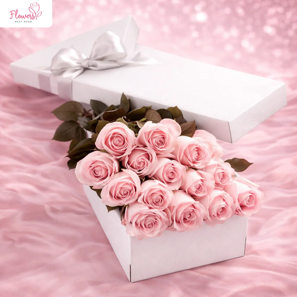 delicate dozen long stemmed pink roses in a box