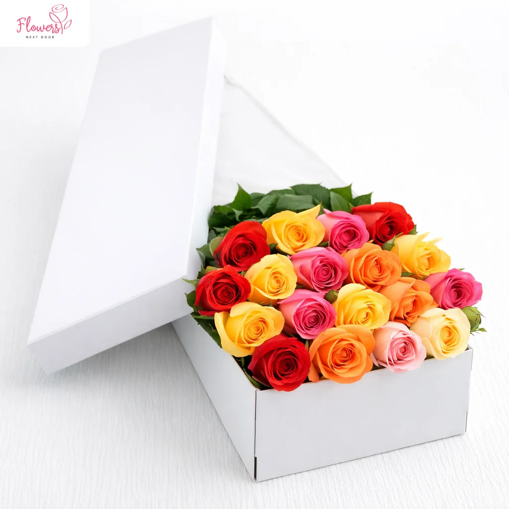 Colorful bouquet of roses in a white box with 'Flowers' logo.