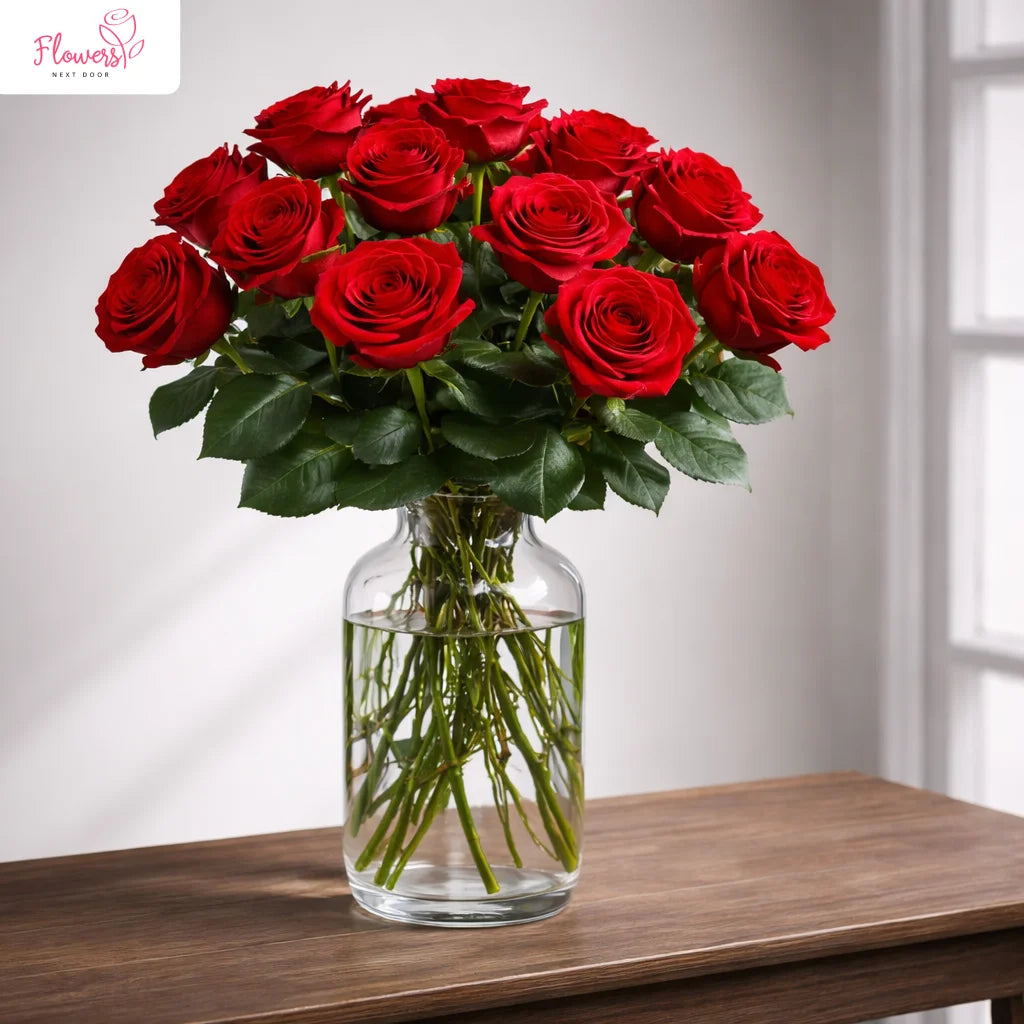 large 12 red roses in a clear glass vase