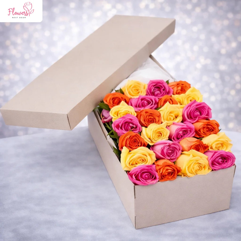 Colorful roses in an open box with a blurred light background